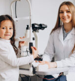 Little girl checking up her sight at ophthalmology center