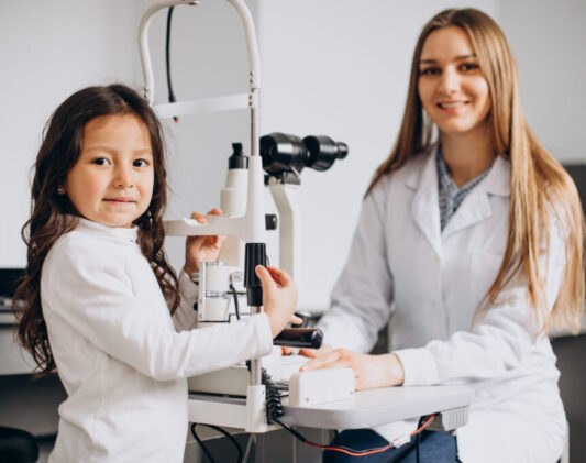 Little girl checking up her sight at ophthalmology center