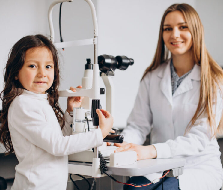 Little girl checking up her sight at ophthalmology center