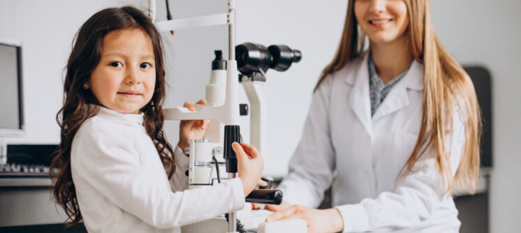 Little girl checking up her sight at ophthalmology center